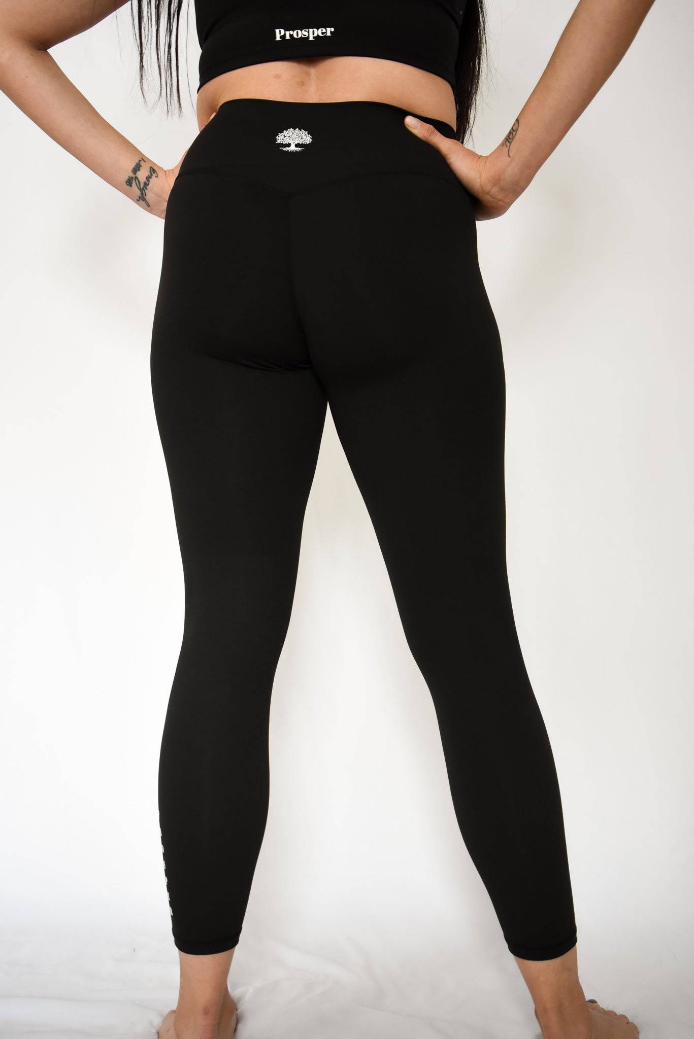 Anthem Leggings Black Backside View with Hands on Hips in Active Stance