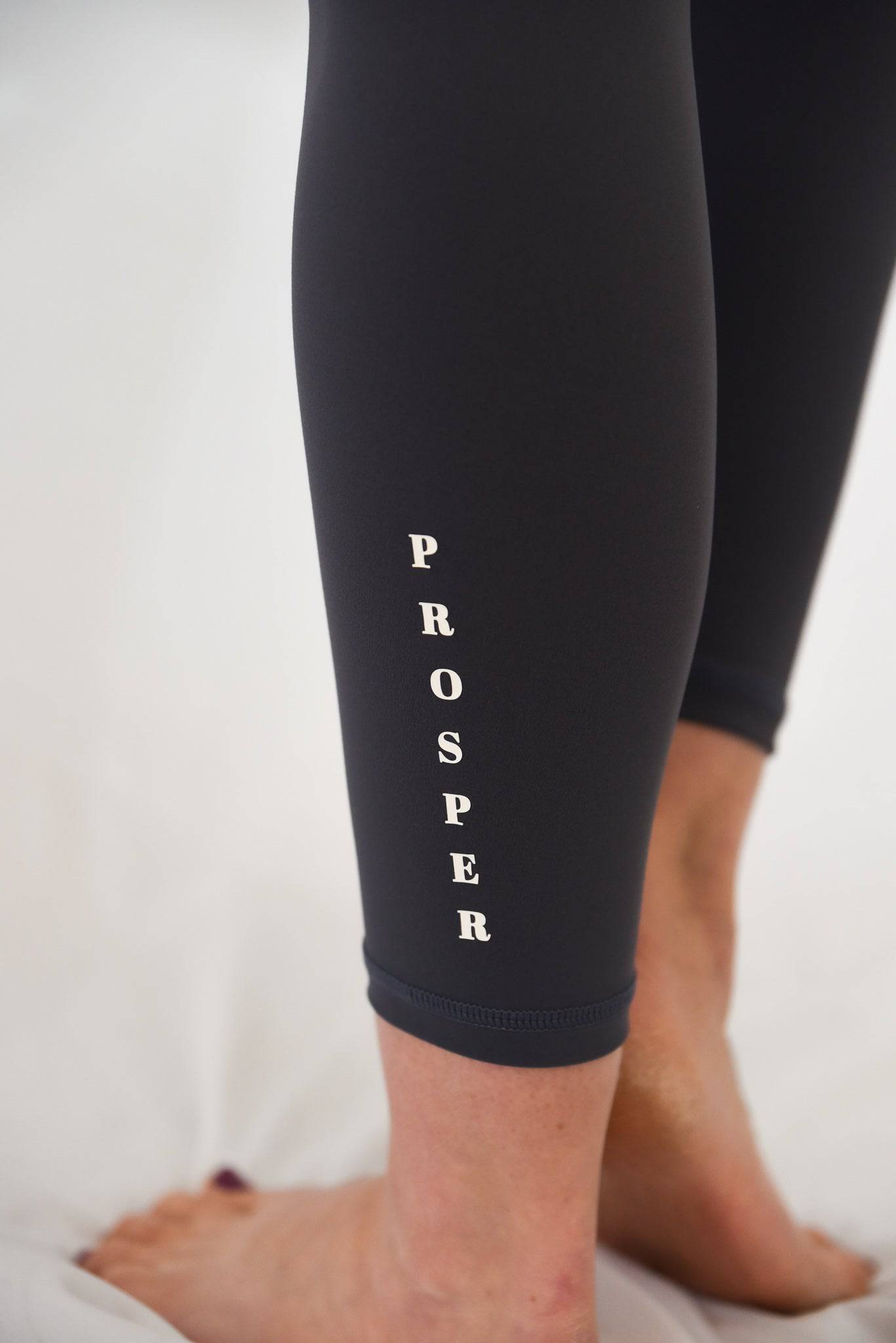 Anthem Leggings Slate Ankle View showing PROSPER on lower left leg