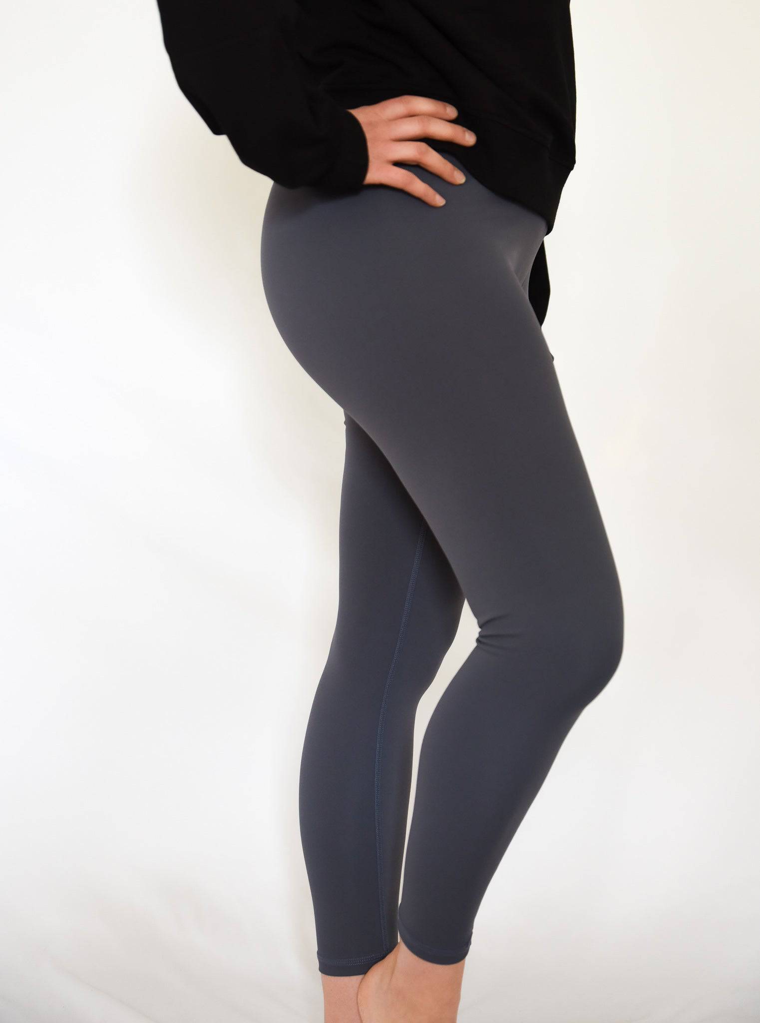Anthem Leggings Slate Side View with hand on hip relaxed position