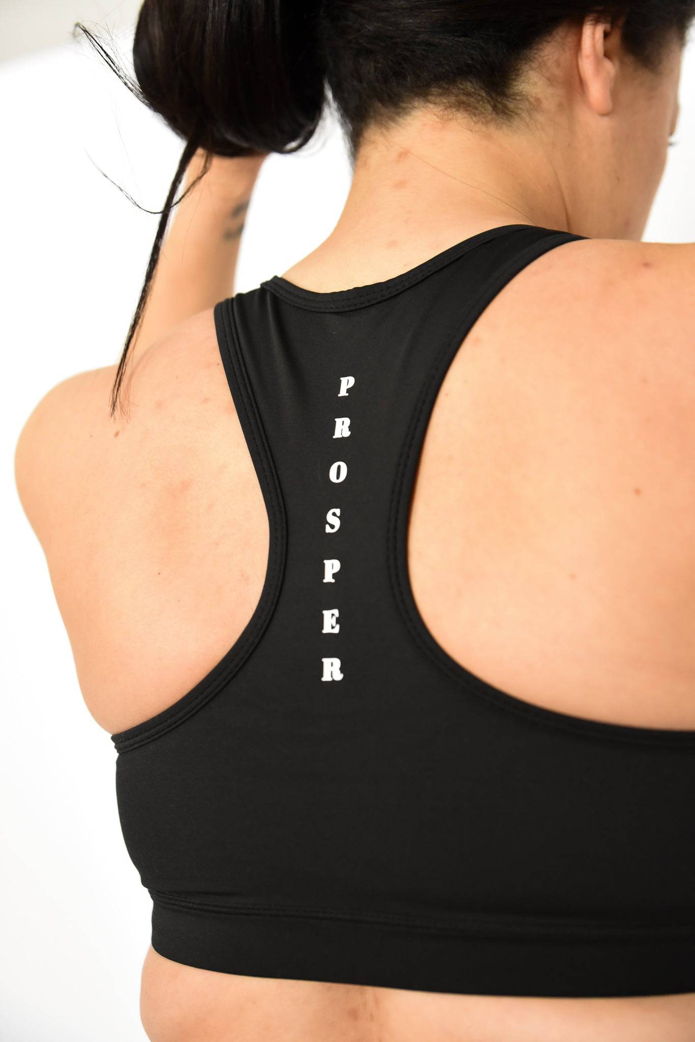Athletic Sports Bra for high impact support showing back view with "PROSPER" written between shoulder blades on racerback design