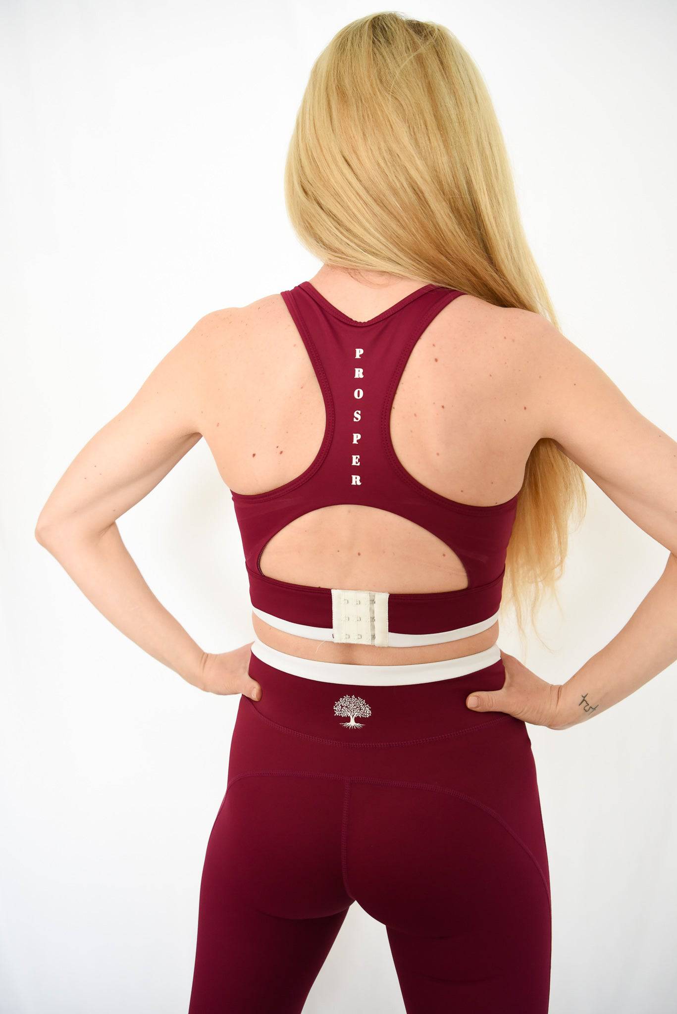 Contender Bra in Cranberry from back showing clasp and "Prosper" written between shoulder blades vertically