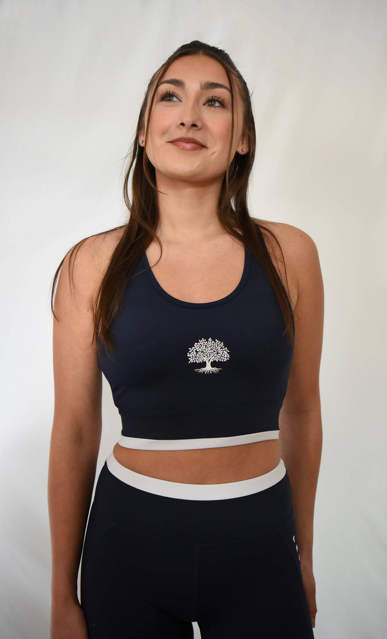 Contender Bra front view in Navy with Prosper Tree logo visible in center