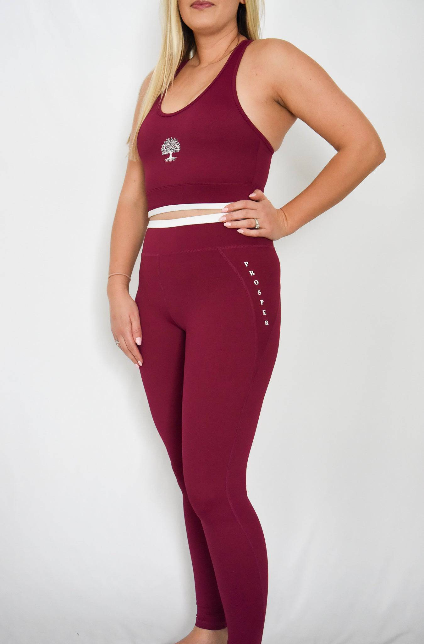 Contender Leggings in Cranberry showing left side view and front
