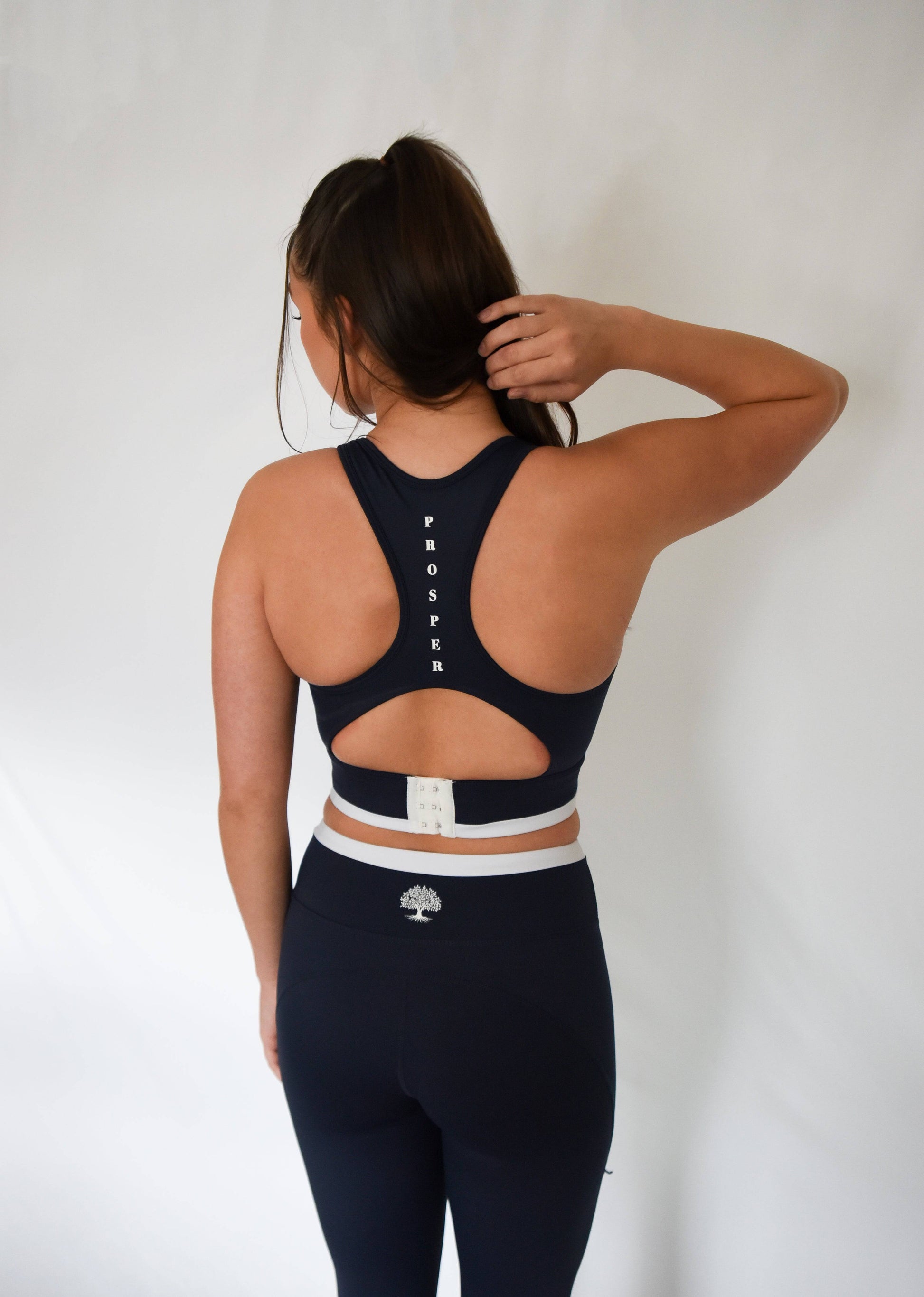 Contender Bra in Navy Blue from Back showing lower clasp and "Prosper" written vertically between shoulder blades